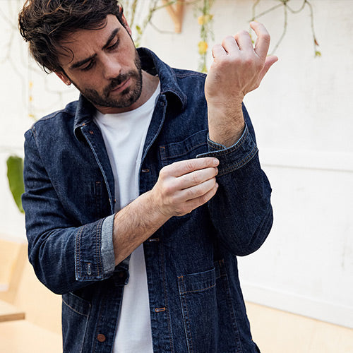 man wearing denim jacket outside